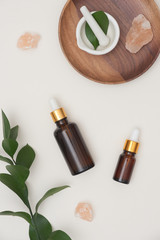 Top view. Essential oil in brown bottles with herbal, message salt on white background. Spa/ beauty product concept.