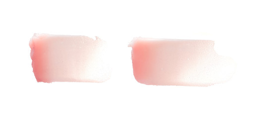 Delicate pink texture and strokes of a cosmetic face mask or cream on a white background