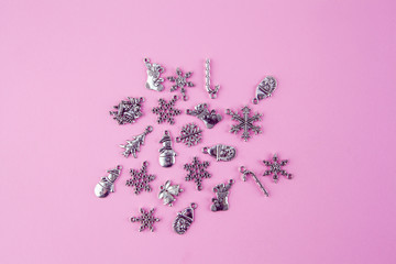 Silver Christmas decorations on pink background - top view with copy space