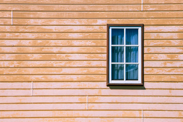 Fototapeta na wymiar Window on wooden weatherboard wall with copy space