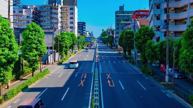 A timelapse of downtown street at Kanpachi avenue in Tokyo daytime wide shot panning