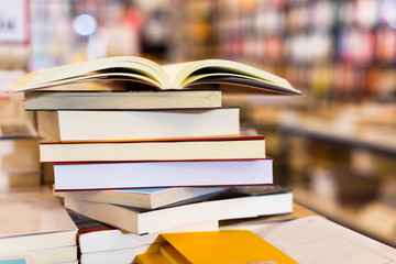 stack of books lying on table in bookstore