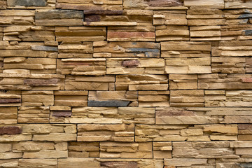 Wall made of decorative stones background texture