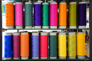 Large colorful polypropylene threads set in rainbow mood. Multicolored bobbin thread. Polypropylene multifilament yarns. Set of sewing thread coils, miscellaneous colours.