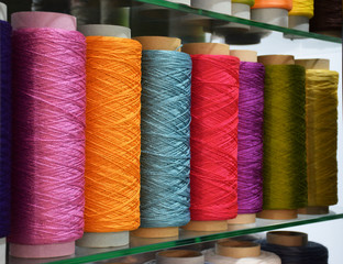 Large colorful polypropylene threads set in rainbow mood. Multicolored bobbin thread. Polypropylene multifilament yarns. Set of sewing thread coils, miscellaneous colours.