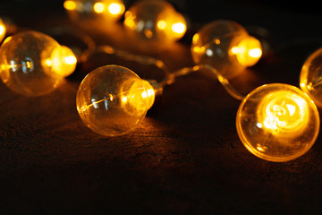 Garland of light bulb lamps in the dark