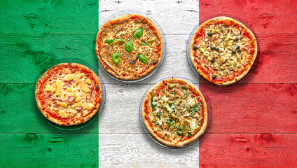 Italy flagged wooden Table with four delicious pizza.