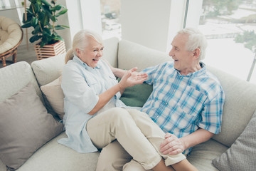 Obraz premium Above high angle view of her she his he two nice attractive cheerful cheery positive people sitting on cosy divan having fun telling sharing stories in light white interior living-room indoors