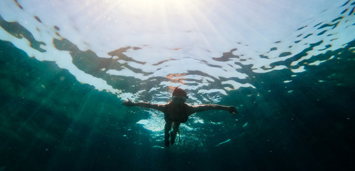 Underwater photo of woman snorkeling in the sea