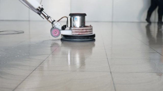 Labor cleaning the floor with cleaning machine