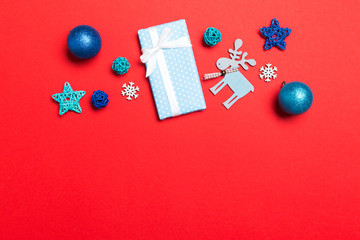 Top view Christmas ball, gift and creative decorations on colorful background. New Year holiday concept with copy space