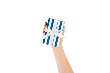 Woman hands give wrapped Christmas or other holiday handmade present in blue paper with white ribbon. Isolated on white background, top view. thanksgiving Gift box concept