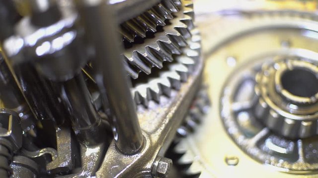 Open gearbox. Gears rotate. Transmission check and repair.Transmission gears closeup detail.