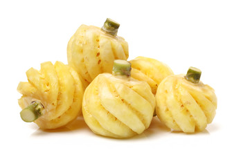 Ripe pineapple peeled on white background