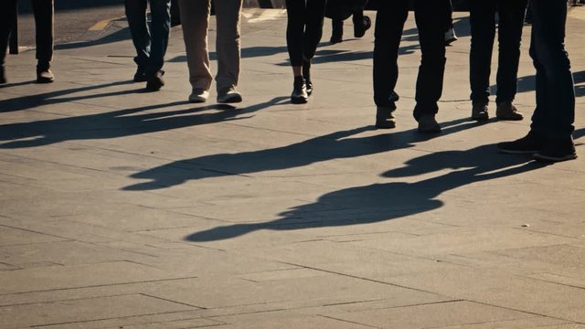 people shadows moving walking under sunlight pavement