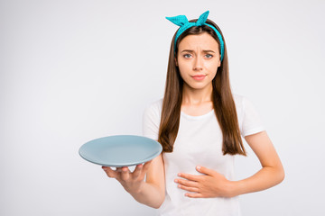 Please give me more food. Portrait of negative unhappy girl follow unhealthy diet starving hold...