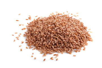 Heap of unpolished brown rice isolated on white background. Side view, close up.