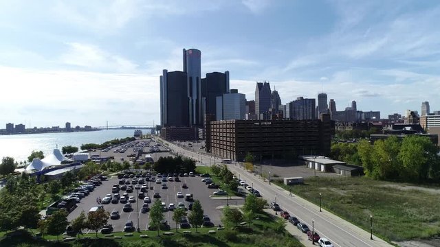 Aerial view of the GM building in downtown Detroit next to a riverfront.
