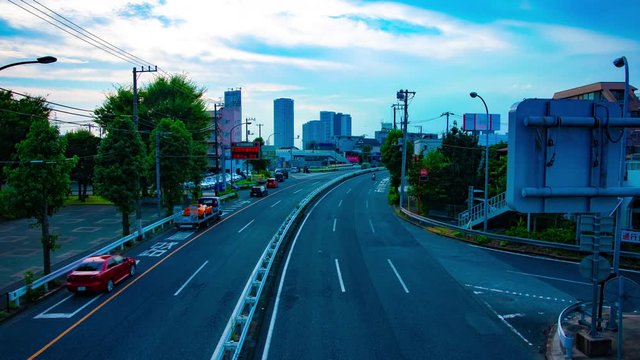 A timelapse of downtown street at Kanpachi avenue in Tokyo daytime wide shot tilt