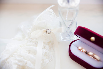 Wedding ring on the bride's wedding garter and spirits