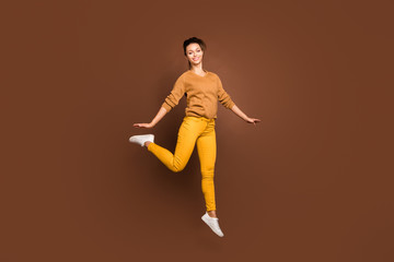 Fototapeta na wymiar Full length body size photo of toothy cute fascinating gorgeous girl jumping up having gone on vacation and being able to do nothing isolated over brown pastel color background