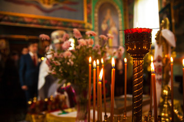 beautiful wedding newlyweds with candles in a church