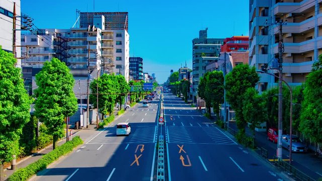 A timelapse of downtown street at Kanpachi avenue in Tokyo daytime wide shot zoom