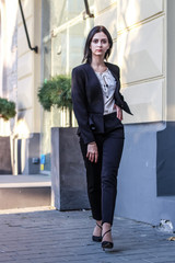 Black haired girl.Business woman in black classic suit.White blouse.Fashion style.