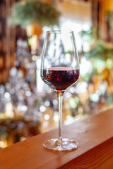 a glass of red wine on the table in the restaurant