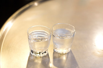 Soju bottle and small glass cup. Alcoholic Clear Distilled Korean Soju.