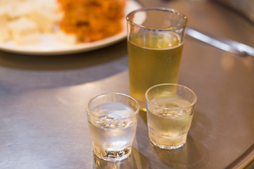 Soju bottle and small glass cup. Alcoholic Clear Distilled Korean Soju.