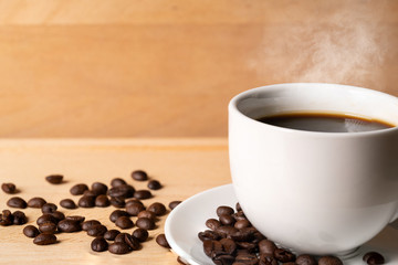 Coffee cup and coffee beans on table