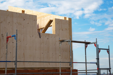 Fototapeta premium Construction of a wooden house, which are a more ecological and economic alternative than homes made of traditional brick and concrete