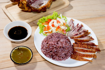 cooked jasmine rice with salad and fried pork leg cooked