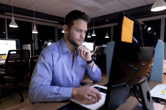 Young male professional working late in creative office 