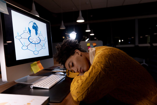 Young female professional working late in creative office 