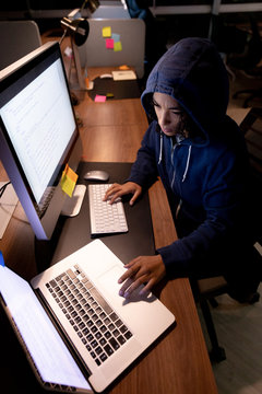 Young female professional working late in creative office 