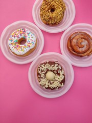 donuts and cup of coffee on wooden background