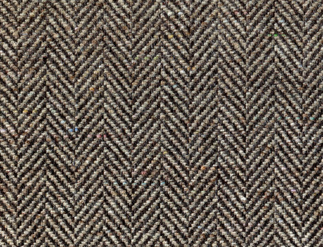 Lambswool Herringbone. Brown woolen fabric striped zigzag. Tweed, Wool Background Texture. Coat close-up. Expensive men's suit fabric. High resolution