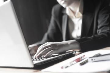 Programmers or hackers type secret codes on a laptop keyboard to break into the corporate database. Cyber concepts or gaming addiction.