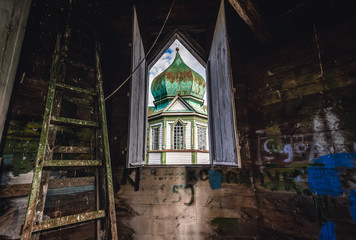 Fototapeta na wymiar Wooden church in Krasne, small village located in Chernobyl exclusion area, Ukraine