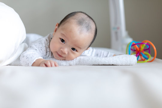 Adorable Baby Boy Doing Tummy Time On Bed