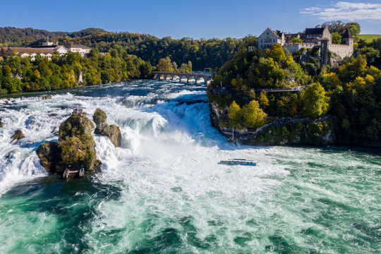 Rhine Falls (Rheinfall), Switzerland panoramic aerial view. Tourist boat in waterfall. Bridge and border between the cantons Schaffhausen and Z&uuml;rich. Cliff-top Schloss Laufen castle, Laufen-Uhwiesen