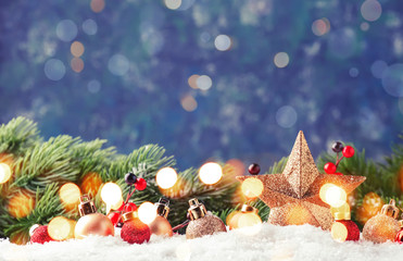 Christmas background with golden star. New Year's decor. Christmas balls in smowdrifts and golden...