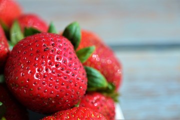 macro fresh strawberry on a light wooden background