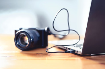 Camera connected to laptop with usb cable. File transfer to computer from DSLR. Back up storage for...