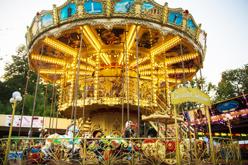beautiful carousel lights in different lights. Summer joy