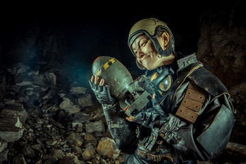 Fototapeta premium Soldier woman with the bomb on post apocalyptic background.