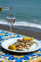 Espeto, Malaga style fish on stick barbecue prepared on olive tree firewoods and white wine