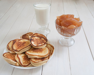 pancakes and a glass of milk with jam in a vase